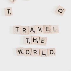 Scrabble tile pieces spelling travel the world