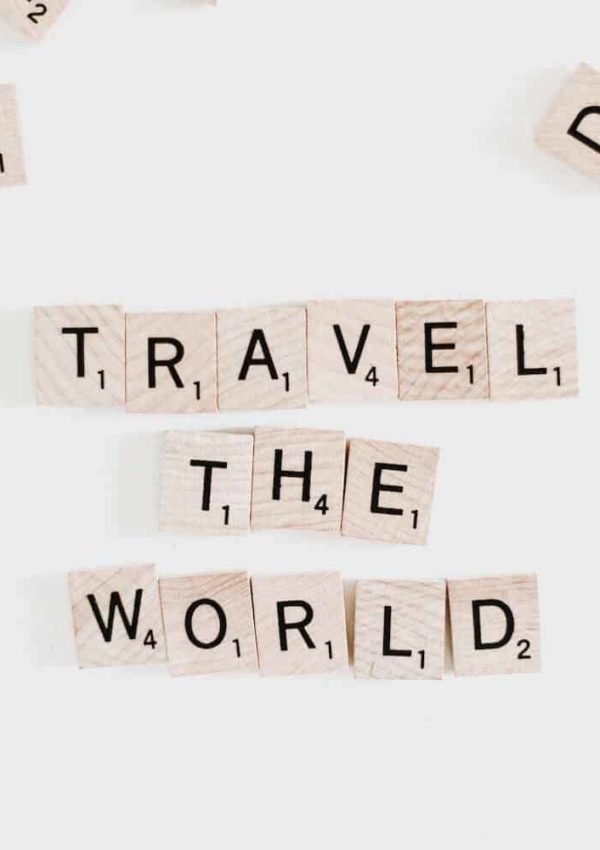Scrabble tile pieces spelling travel the world