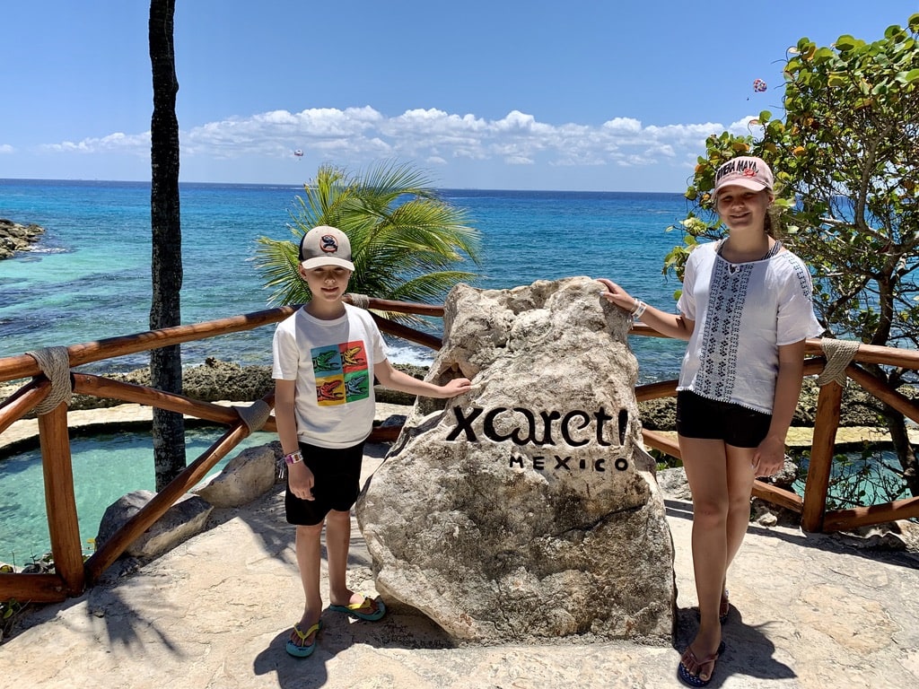 Kids posing in front of the beautiful ocean at Xcaret, Mexico 