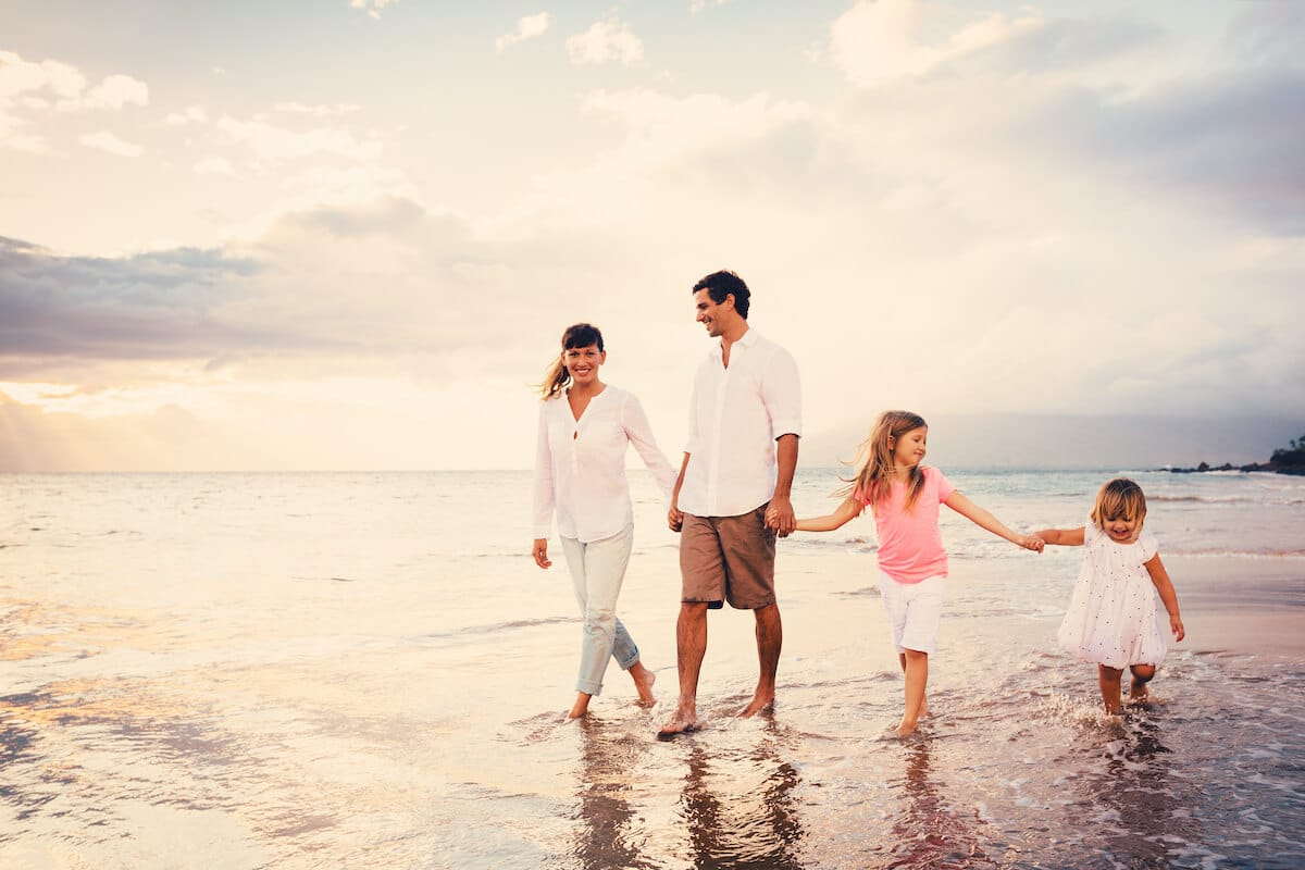 Family vacation picture while walking together on the beach