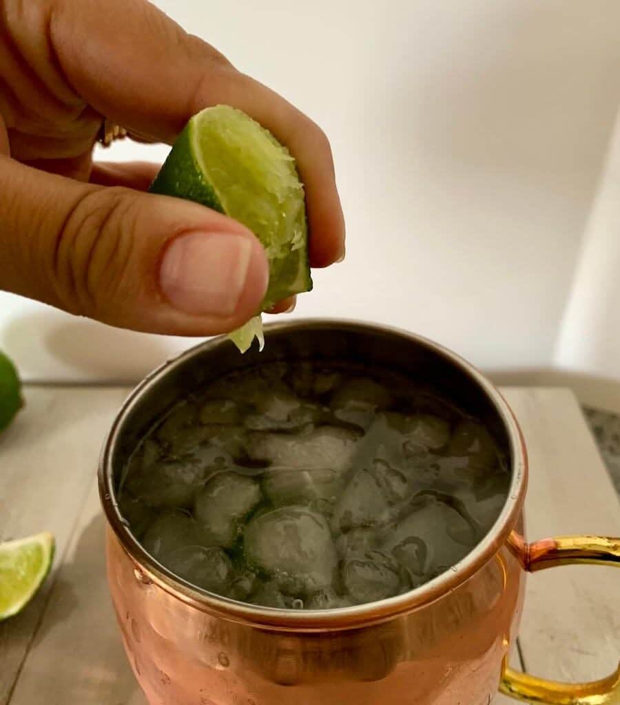 Squeezing a lime into a classic Moscow mule